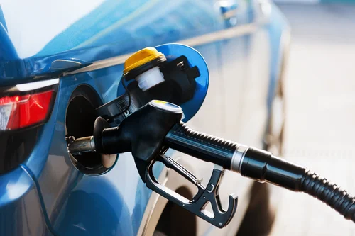 Gas pump inside of car putting gas inside
