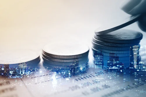 stacks of coins with futuristic cityscape in background
