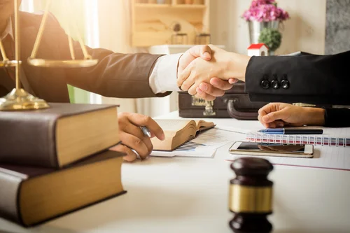 handshake law books on desk