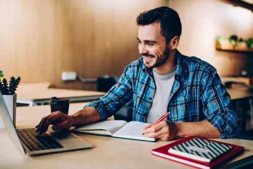 man smiling using laptop computer