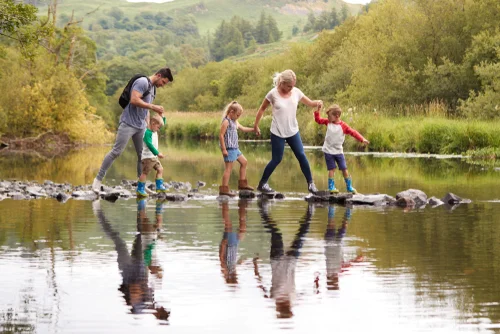 family crossing river