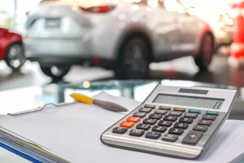 calculator on a desk inside a car dealership